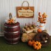 Miniature Fall Scene With Bale Of Hay, A Barrel, Caramel Apples, Pumpkins, A Fall Flower Arrangement, And A "Caramel Apples For Sale" Sign