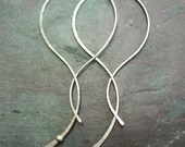 Sterling silver hammered abstract organic hoop with long tail. Medium sized one-piece women's earrings.