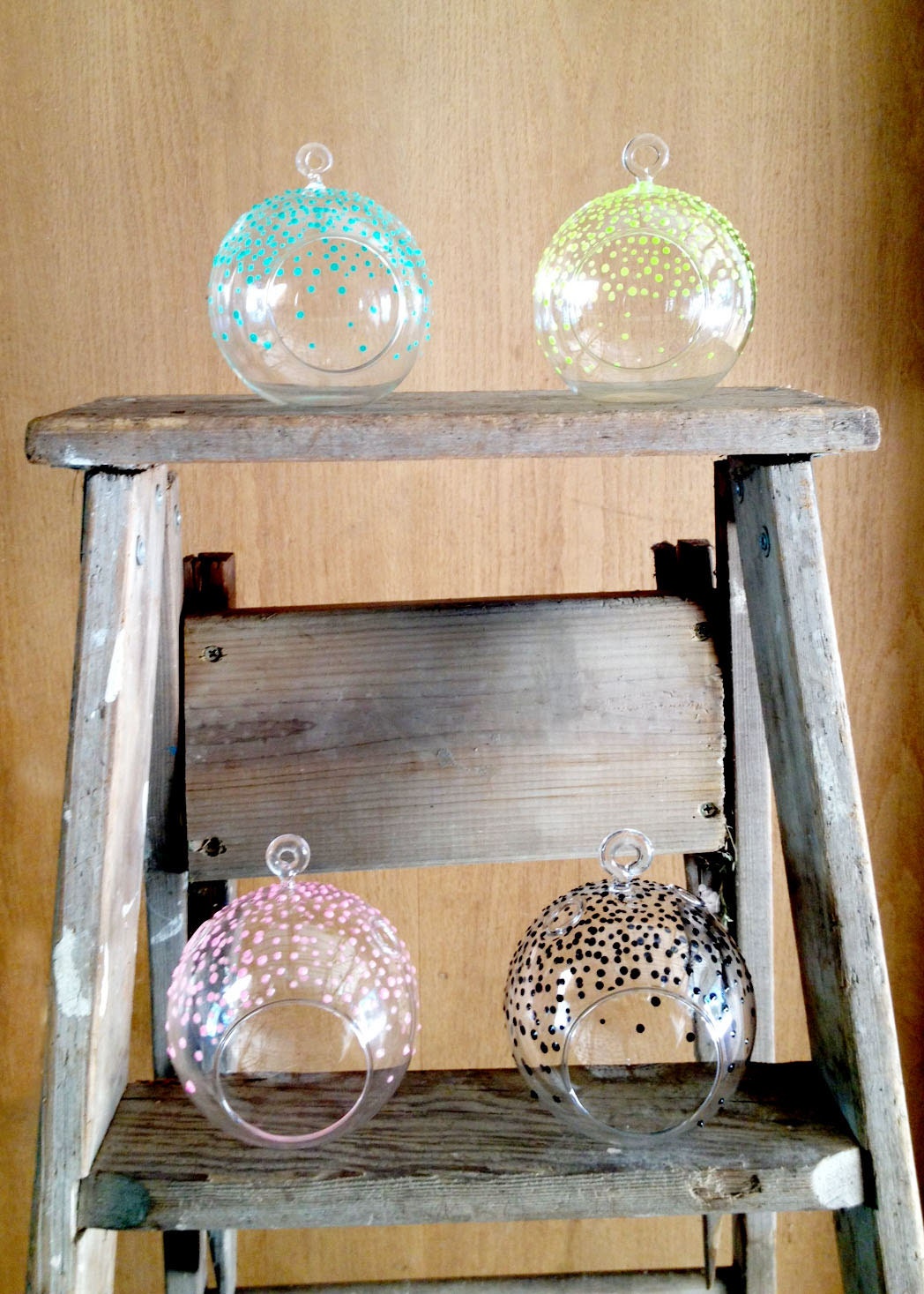four hand painted hanging glass terrariums. One of each color, Just add your air plant. Cute desk accessory.
