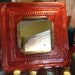 Antique pumpkin orange colored tin ceiling tile mirror
