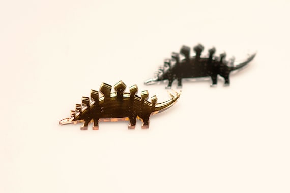 Two stegosaurus lasercut brooches