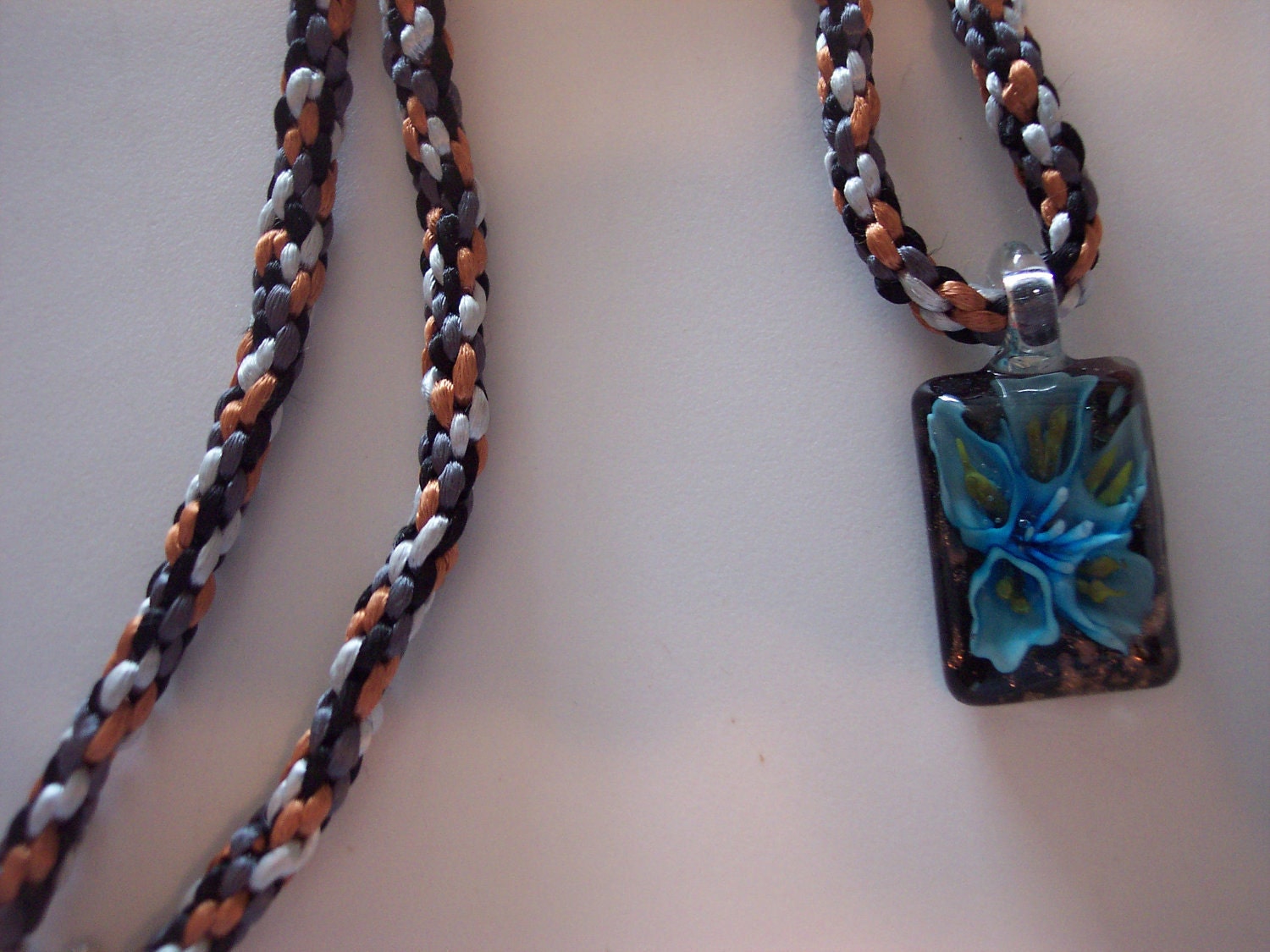 Kumihimo in blues and browns braided necklace with glass flower pendant
