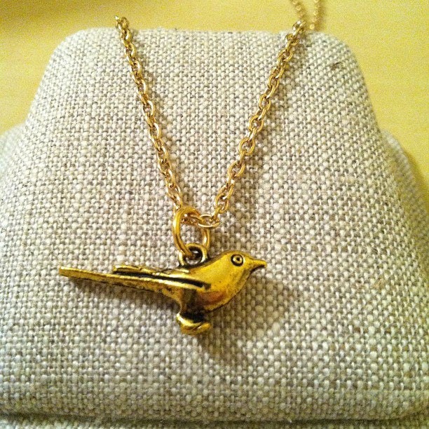 Gold chain necklace with bird pendant