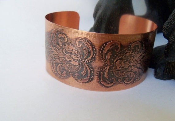 Copper cuff bracelet created from sheet metal and etched with a floral design