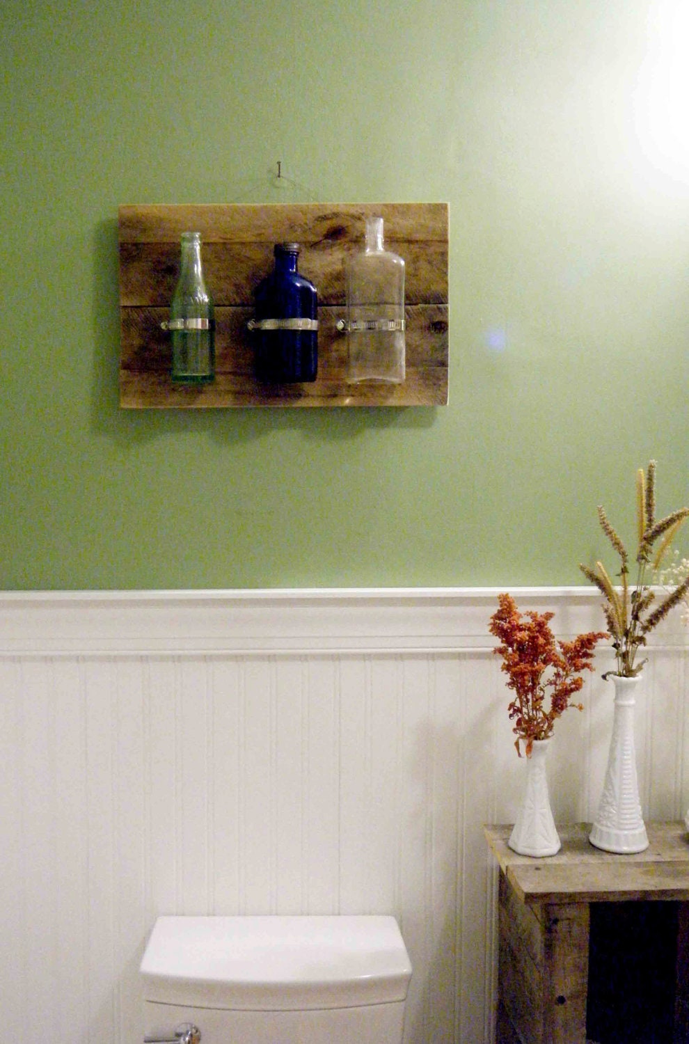 Vintage bottle wall hanging on reclaimed wood