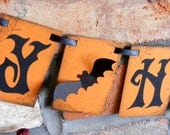 HAPPY HALLOWEEN banner garland decoration in rustic orange and black with spider webs and 3D bats