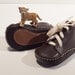 Baby shoes in chocolate brown colour, 100% leather inside and outside. Beige cotton laces