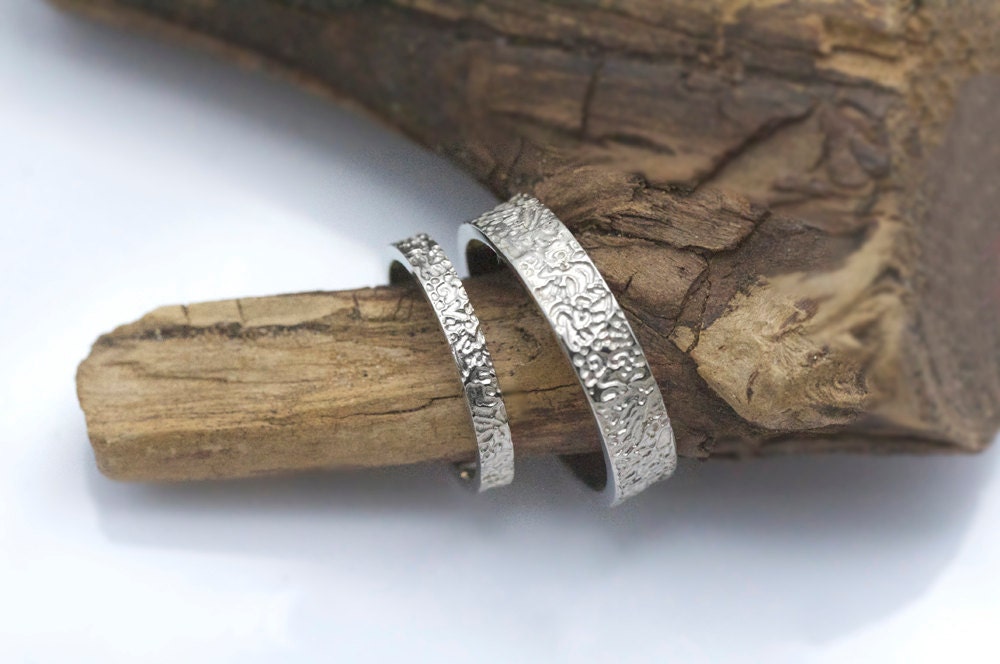 His and hers matching wedding bands in 14k white gold, 5mm and 3mm, texture rings