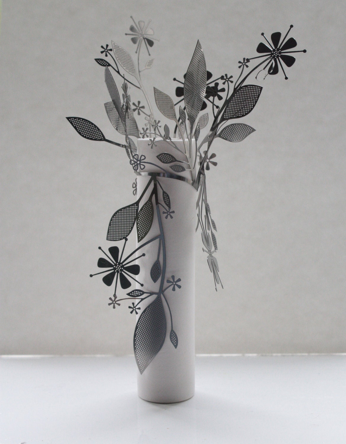 Metal foliage wrapped around an English fine bone china tall tube