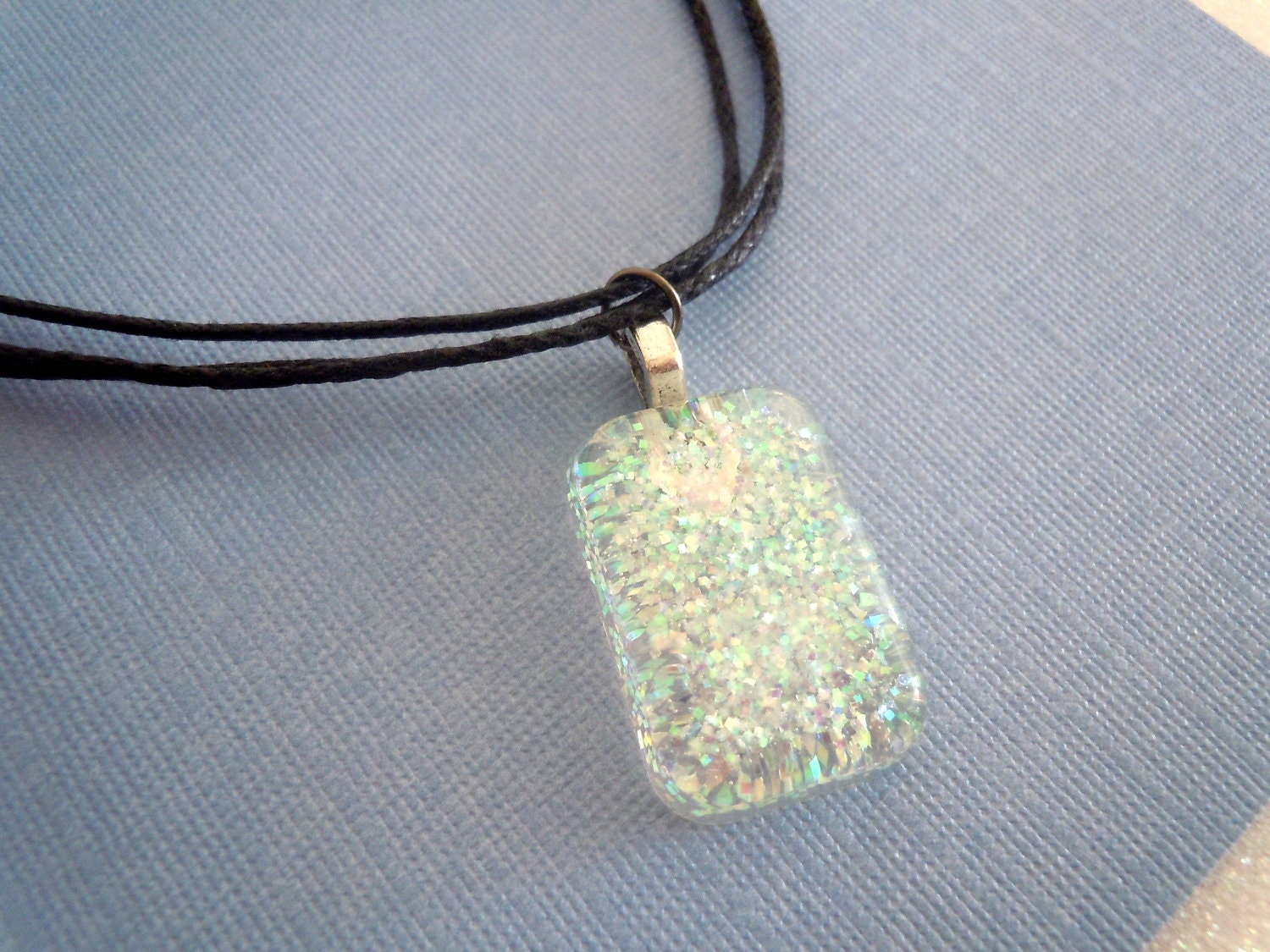 White glitter charm(b) -- black cord necklace