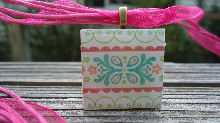 Patterned Necklace with Pretty Flowers Pastel Colors on Wood Tile