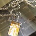 Iris and Lily. Brass and glass two sided locket featuring Mucha paintings. Two necklaces in one.
