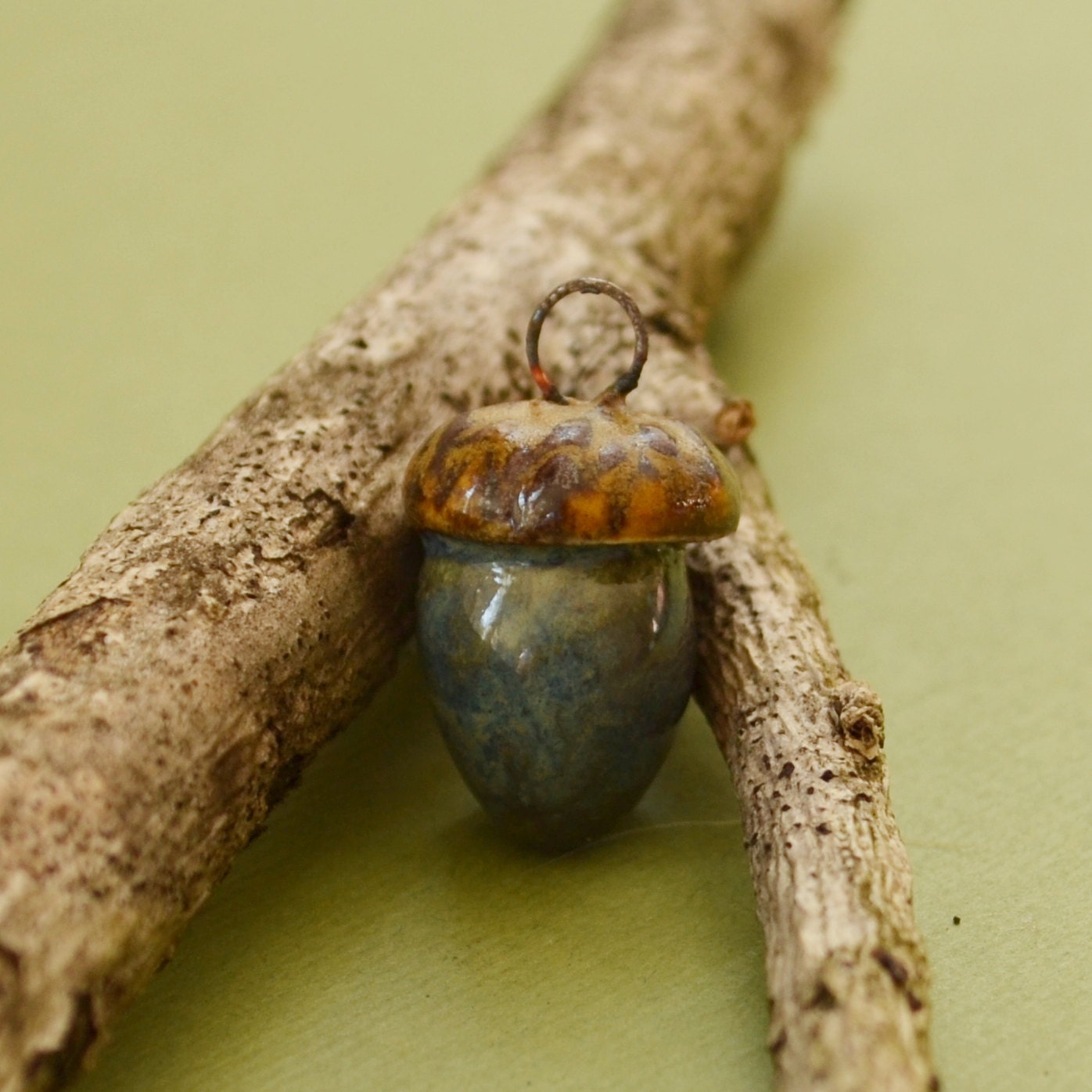 Acorn charm in rusty cream