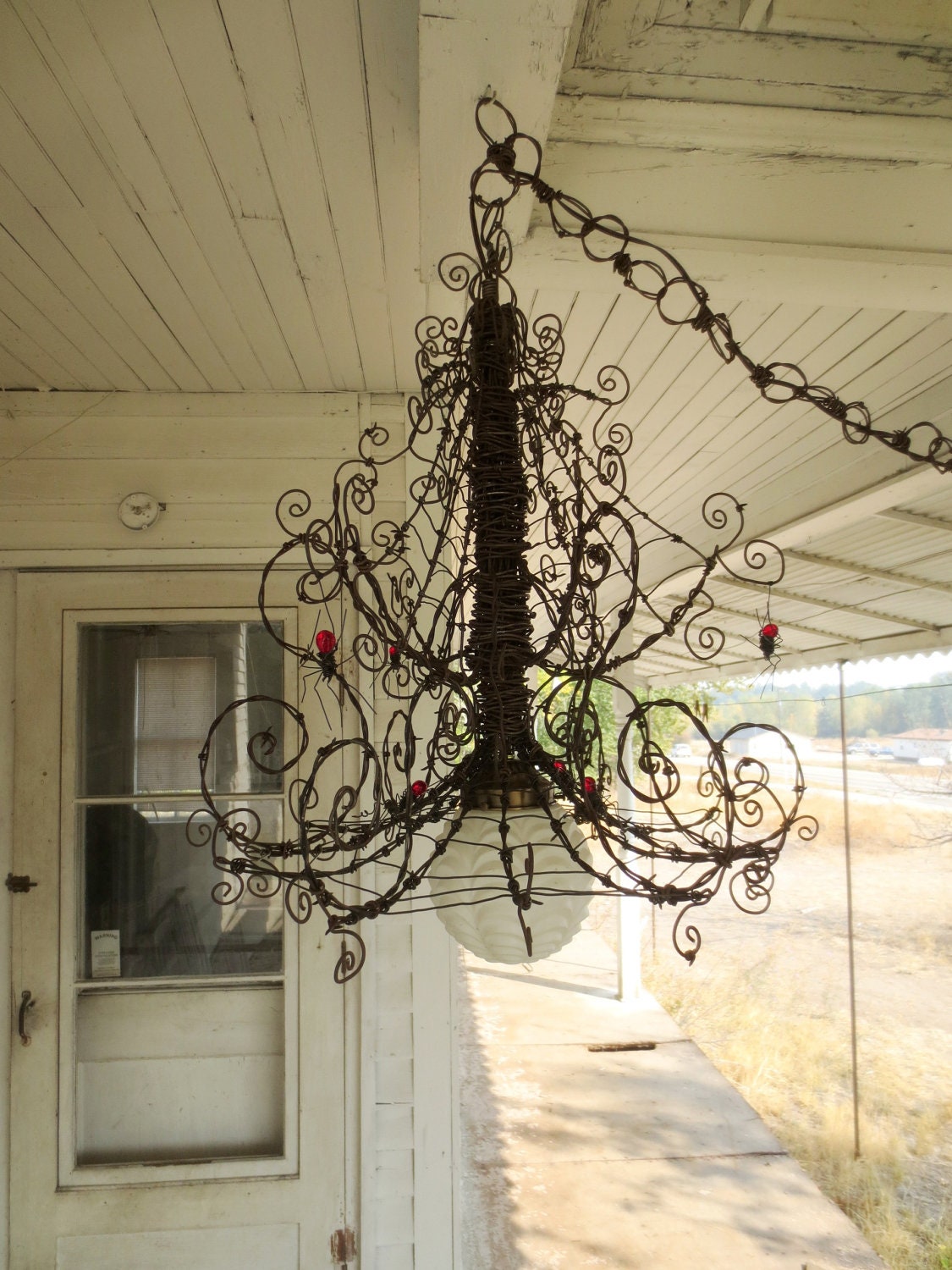 Barbed Wire Chandelier Infested With Spiders and Festooned With Webs