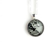Black and white illustration necklace made with vintage sheet music.  Mediterranean seaside village town scene