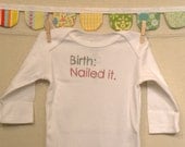 birth: nailed it --- white long-sleeved onesie, size 0-3 months --- pink