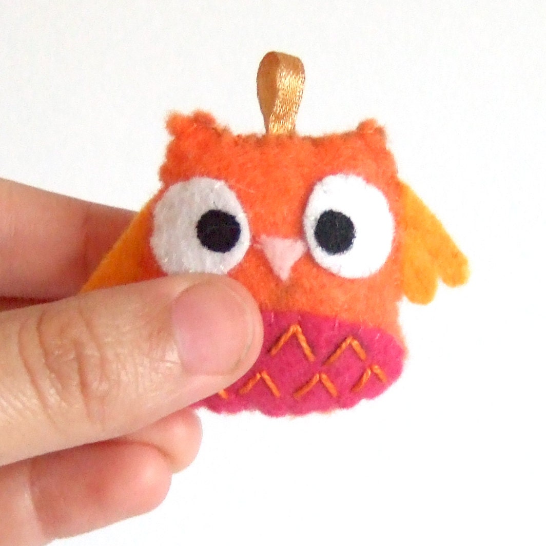 Very orange, and a bit of pink happy owl keychain plushie