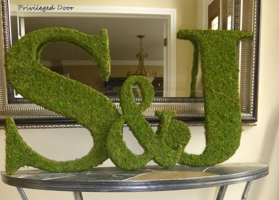 Letters covered in moss