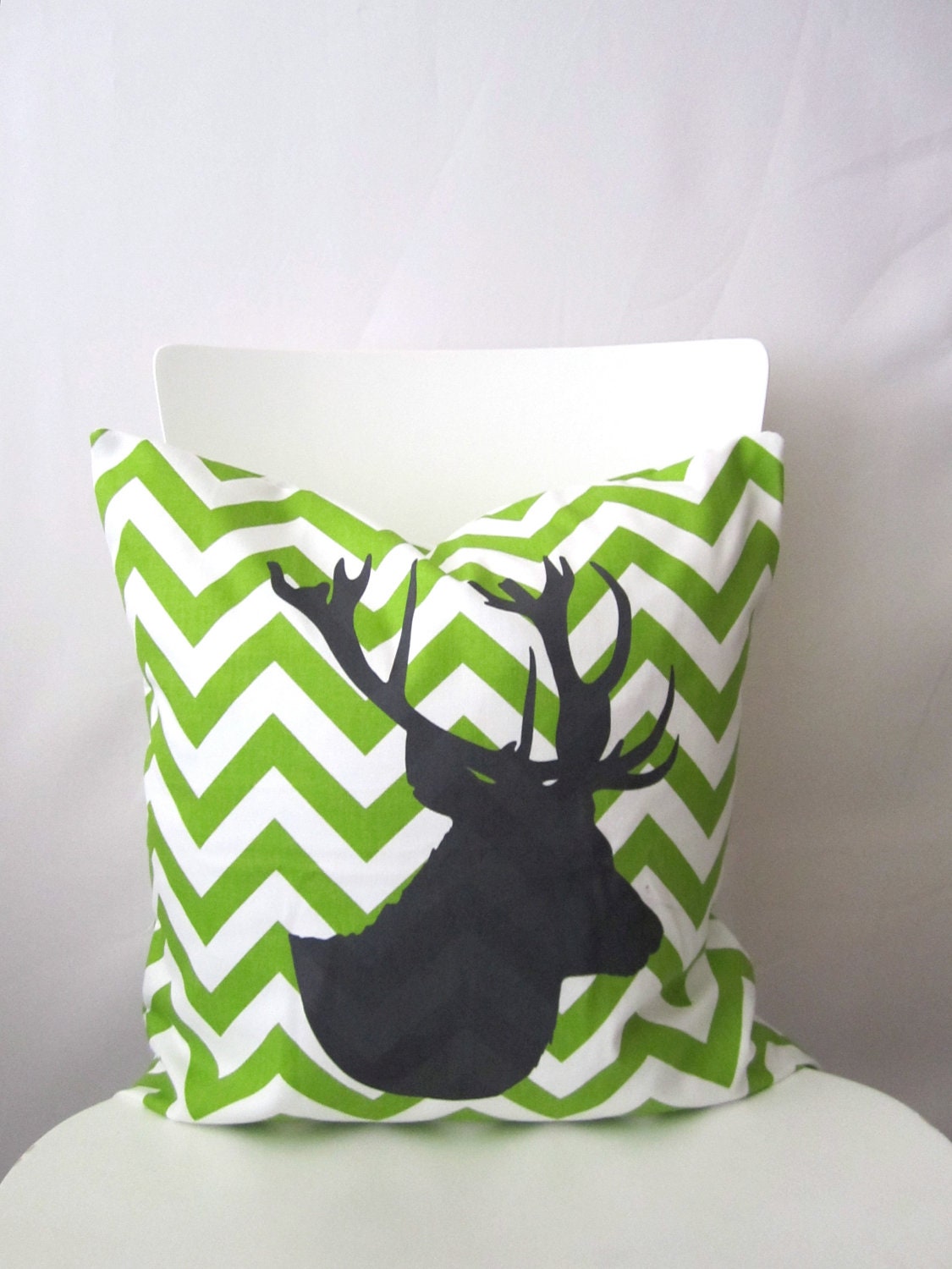 18 inch throw pillow cover, Chevron with stag silhouette deer head, chartreuse lime color. Zigzag pattern, modern print. For indoor use.