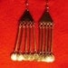 Tiny little silver coins dangle at the end of these bellydance looking earrings.