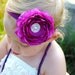 Large fuchsia ranunculus flower with pearl center on solid elastic or glitter elastic headband