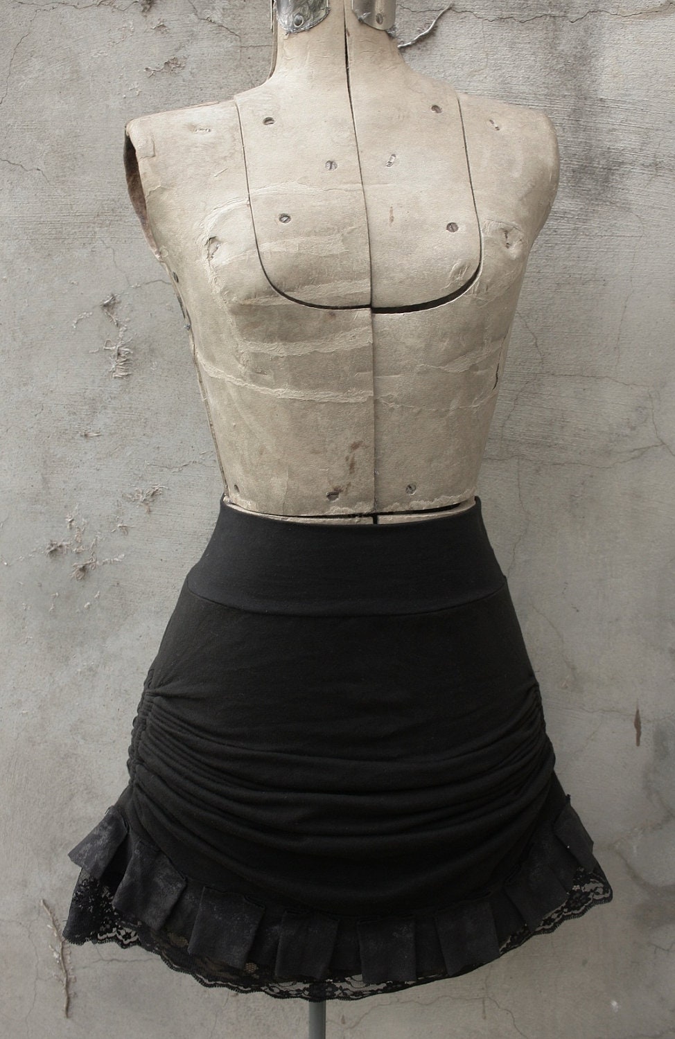 High waisted skirt. Adjustable length and box pleated hem.
