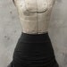 High waisted skirt. Adjustable length and box pleated hem.