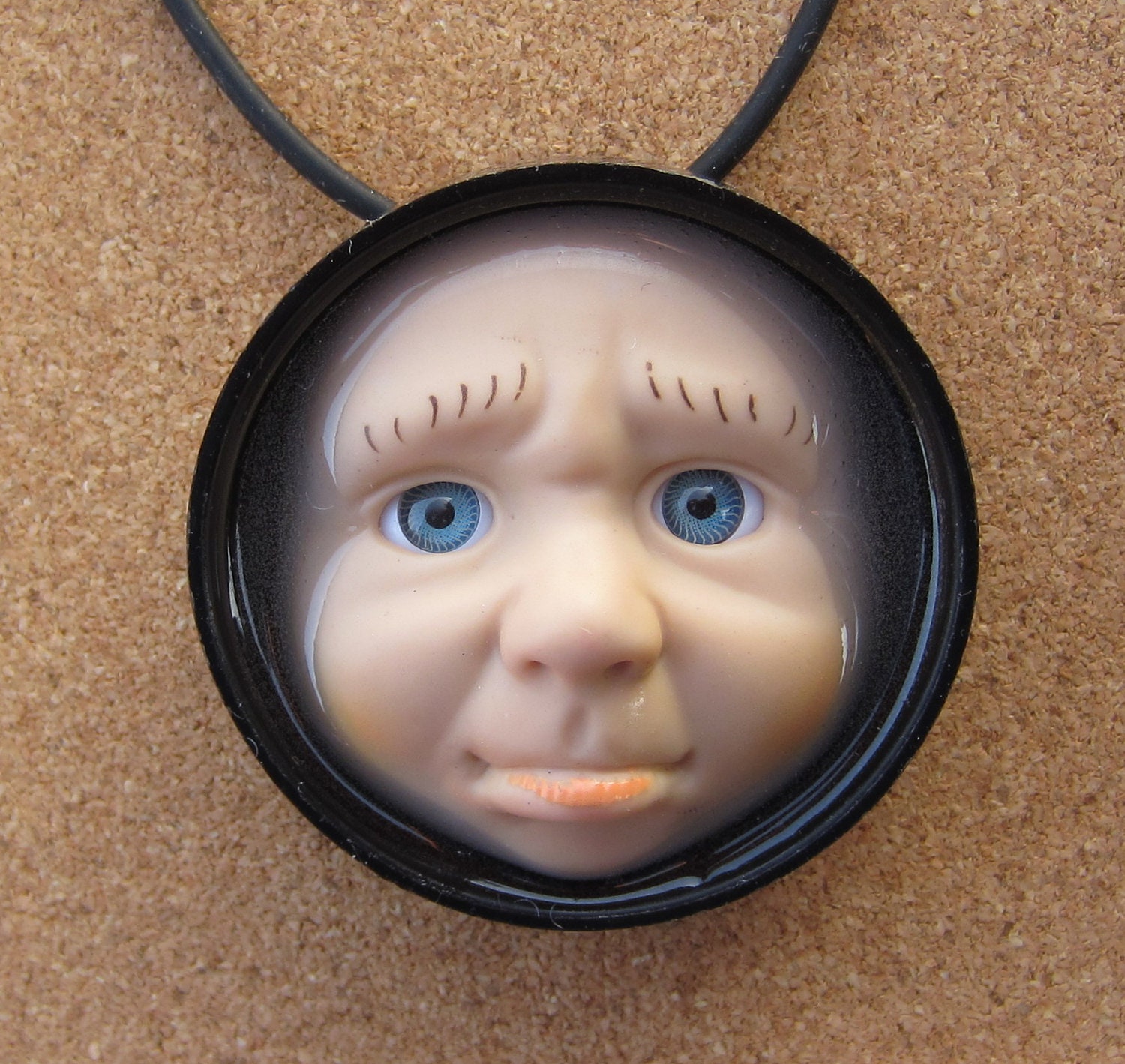 The Pouter - Upcycled Doll Face Pendant