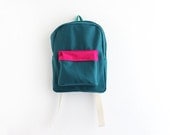 Teal wool backpack with magenta pouch.