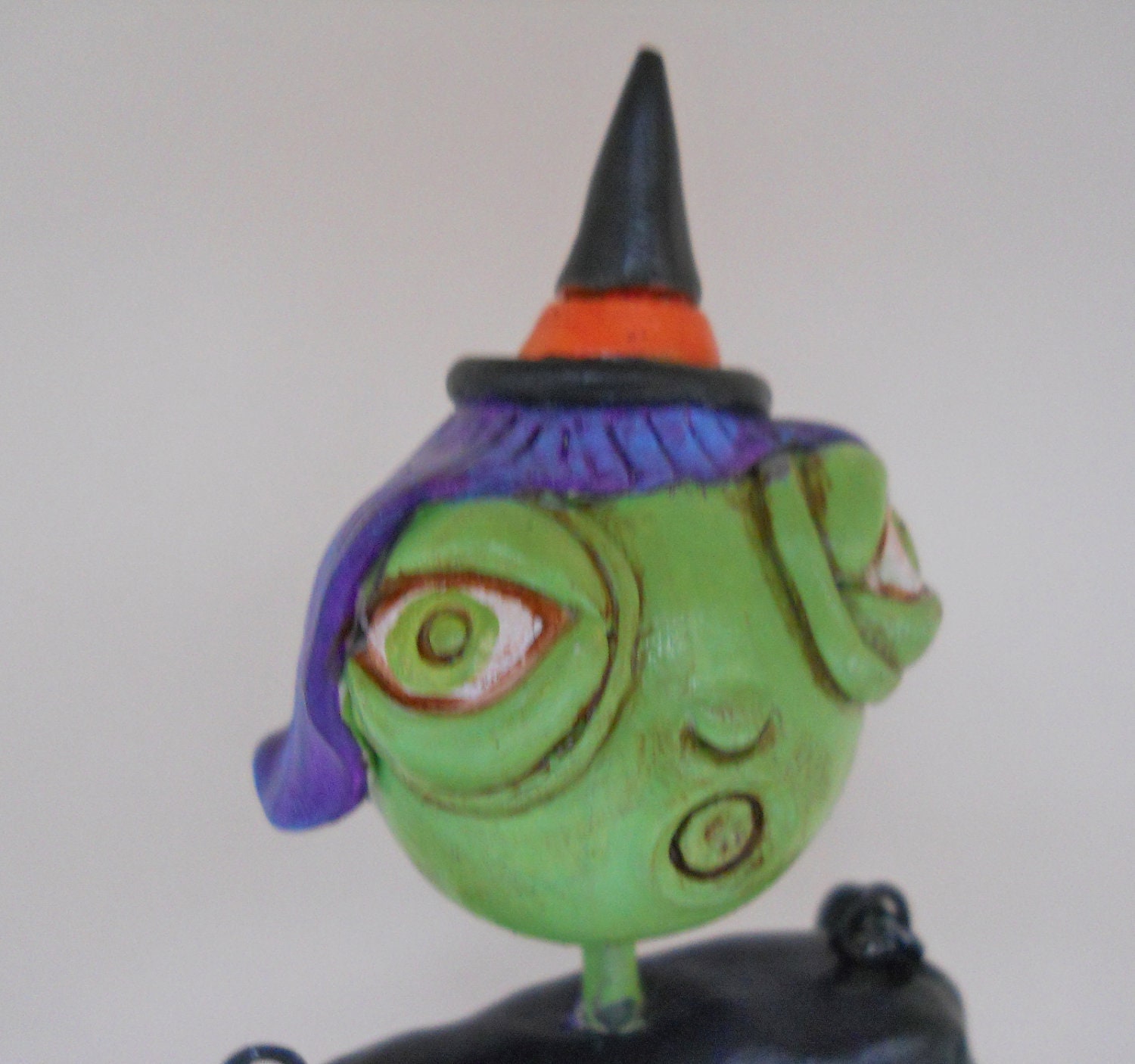 Halloween Witch in White Black Orange Purple and Green with a Skeleton Bucket