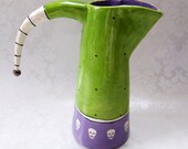 green & purple skulls ceramic pitcher with striped handle