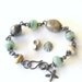 wire wrapped bracelet with aqua lampwork beads, fossilized coral, and sterling silver