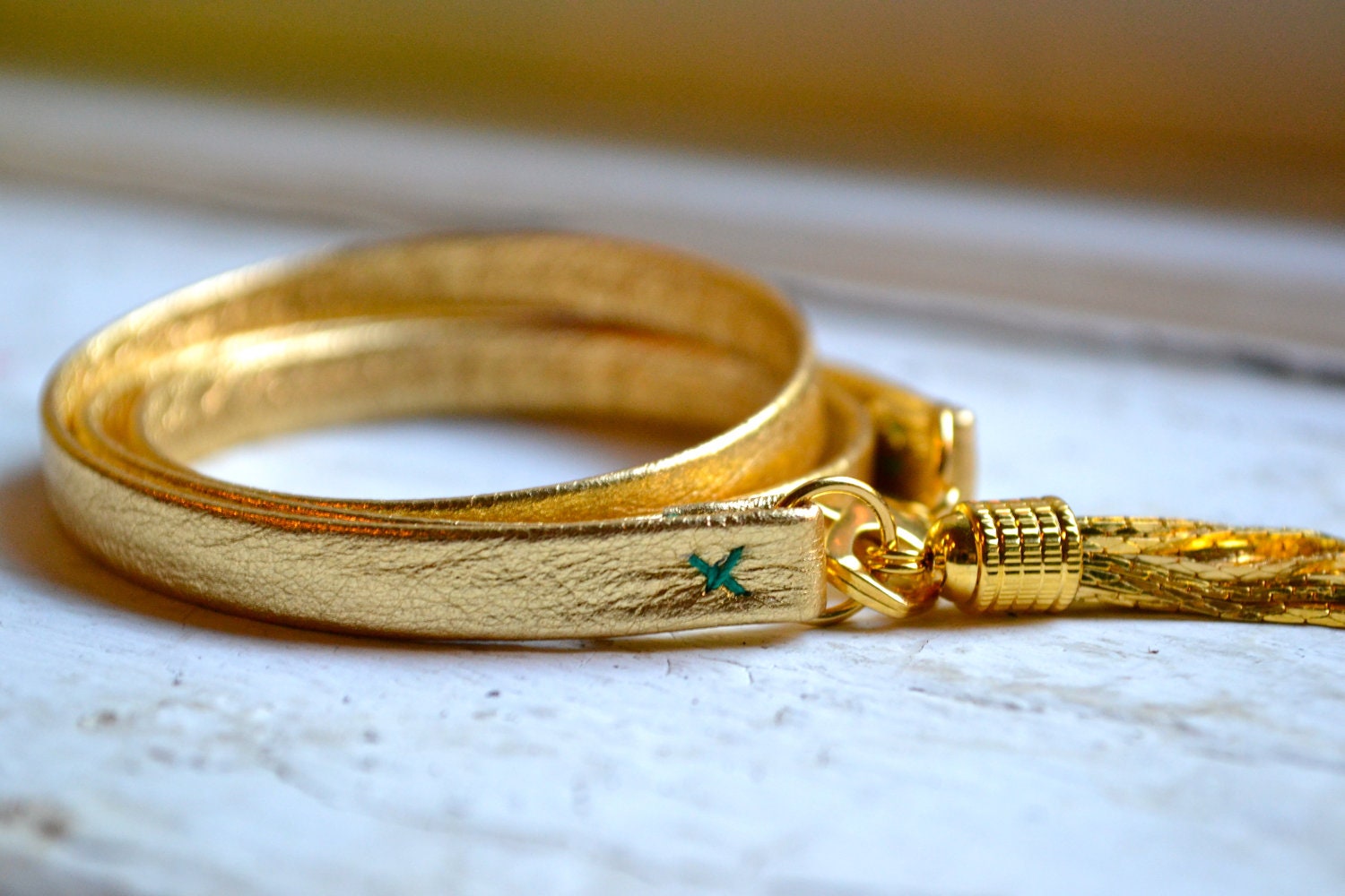 metallic gold genuine leather & gold triple wrap bracelet with tassel