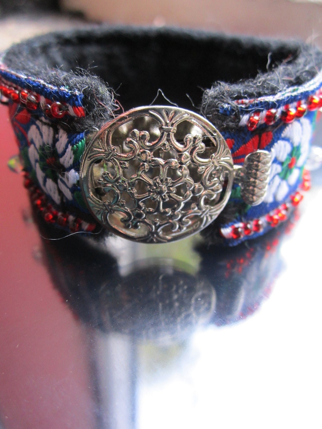 flower cuff bracelet in vibrant red, green and blue with beaded accents and flower clasp