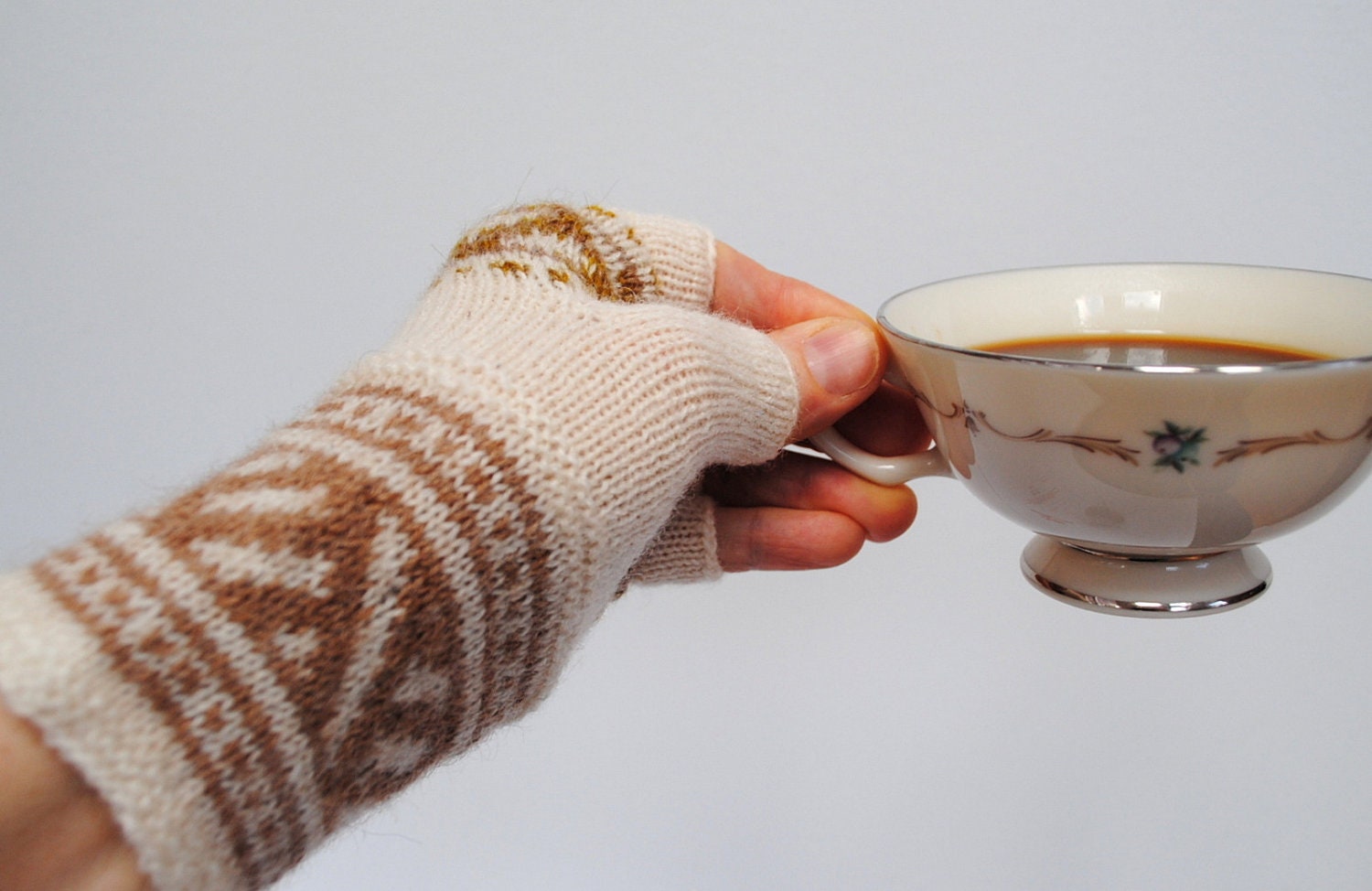 Half finger gloves. White wool knitted gloves with Latvian mitten ornament.