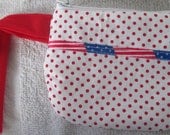 Small coin purse with wrist strap and zipper closure. Red, white and blue