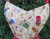 Handmade apron with vintage utensils and red and white dotted ruffle