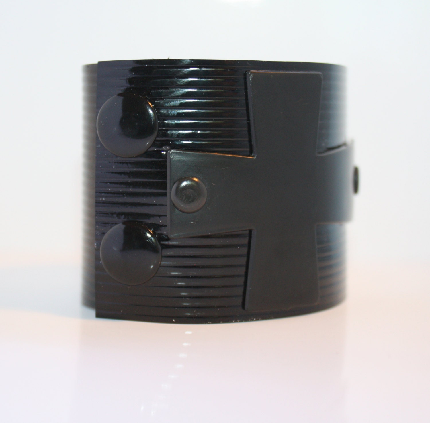 Sideways Black Metal Cross on Black Embossed lined Cuff
