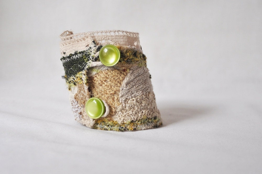 Upcycled asymmetrical beige green cuff made of recycled sweaters. Decorated with vintage cotton lace. Upcycled accessories Eco friendly