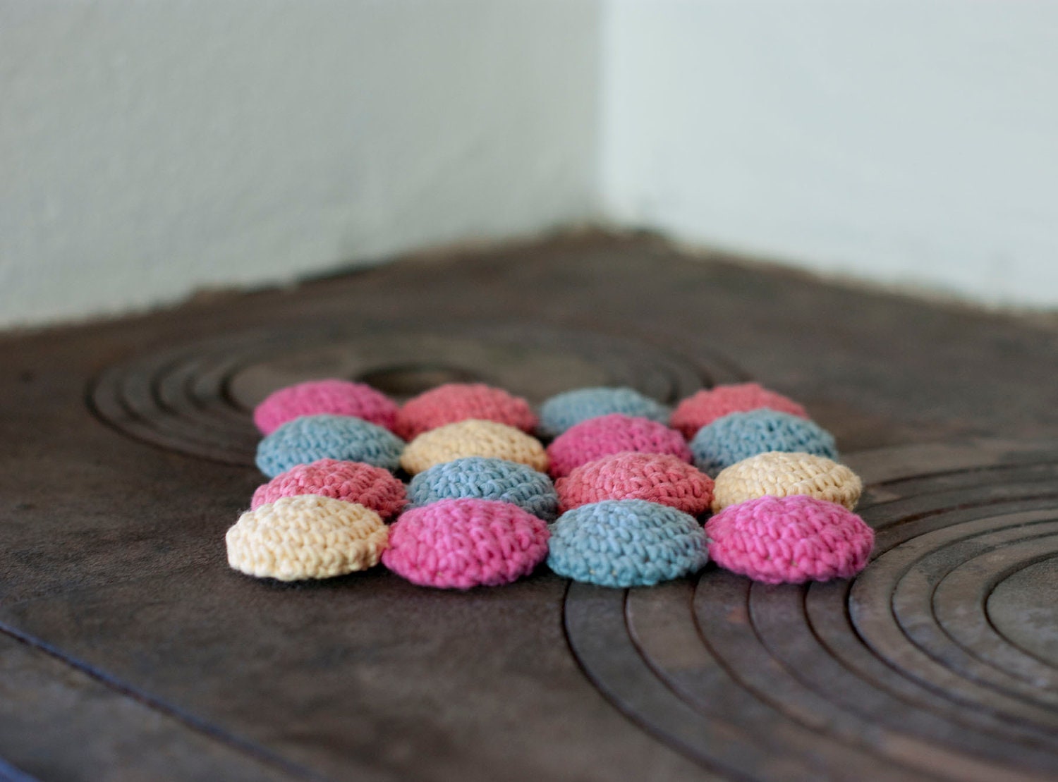 Eco cotton and wood trivet in pastels. Crocheted circles in pink, peach, yellow and blue. Eco friendly.
