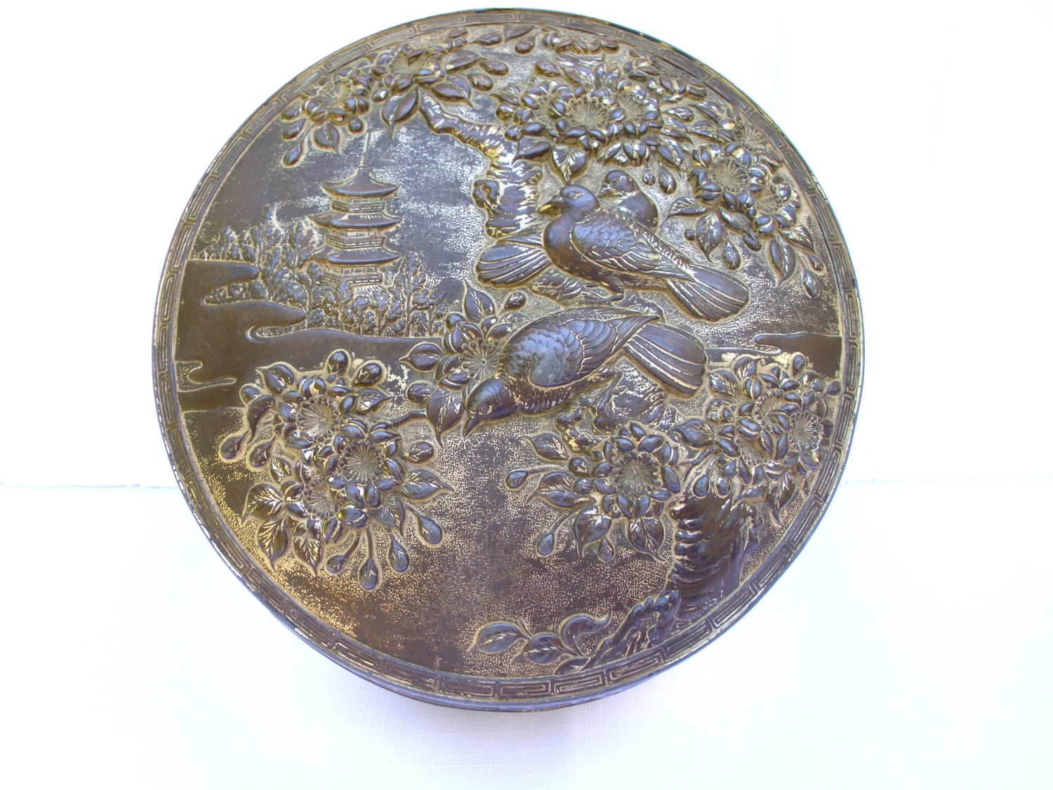 Old round embossed metal jewelry box Asian motif serpents birds decor