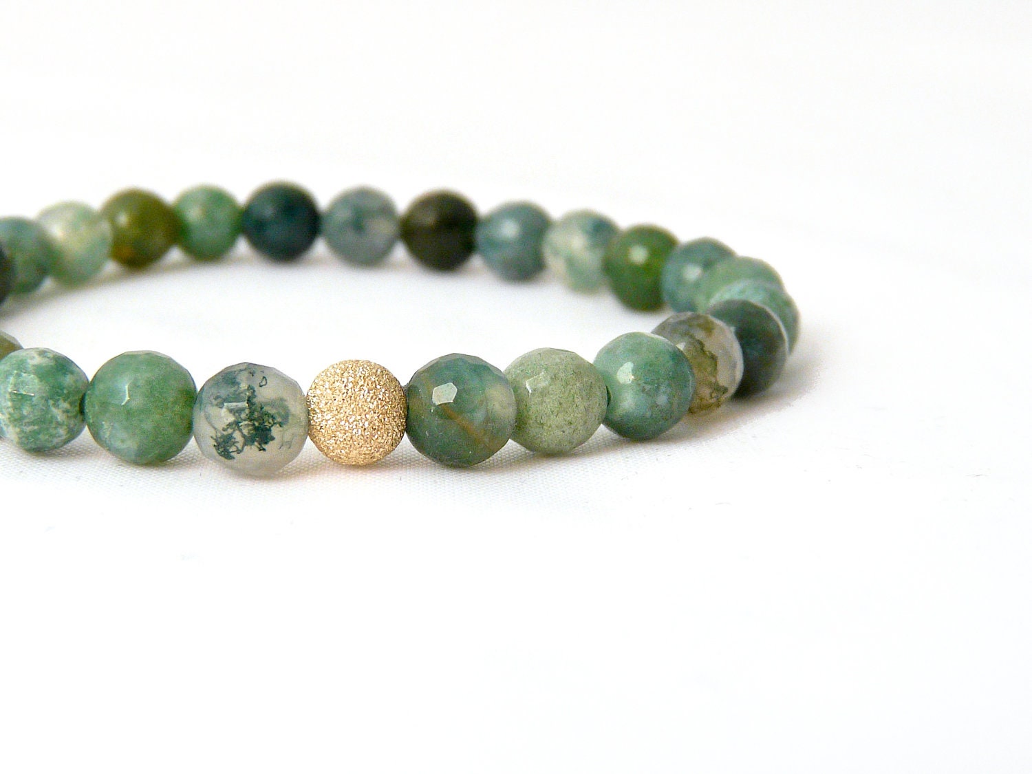 moss agate bracelet with gold focal bead. small stacking yoga stretch bracelet in green, teal, olive and aquamarine.