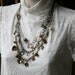 Beautiful multi strand and color medium length necklace with charms crystals and pearls