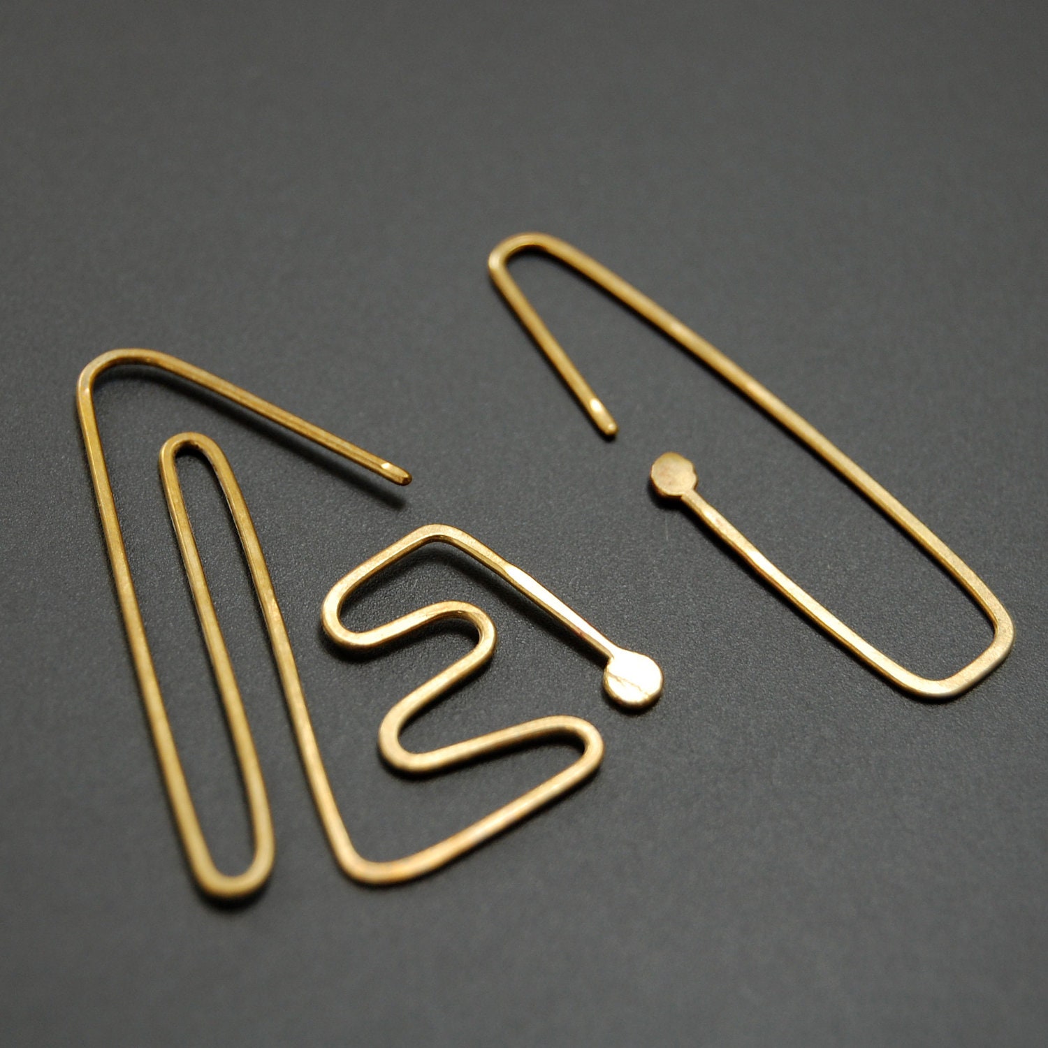 Nazca lines dangle earrings, brass