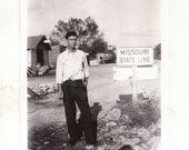 Great Vintage Photograph of a man standing in front of the missouri state line
