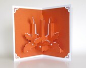 Christmas Candles 3D Pop Up Greeting Card Home Décor Handmade Cut by Hand Origamic Architecture in Festive Golden Metallic Copper and White.