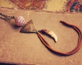 rust.  a bohemian fringe coyote tooth necklace.