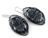 Stylish, modern, oversize shiny black earrings.  Wire abracadabra style.  Fashionably designed in Fashion Brand Faina studio.