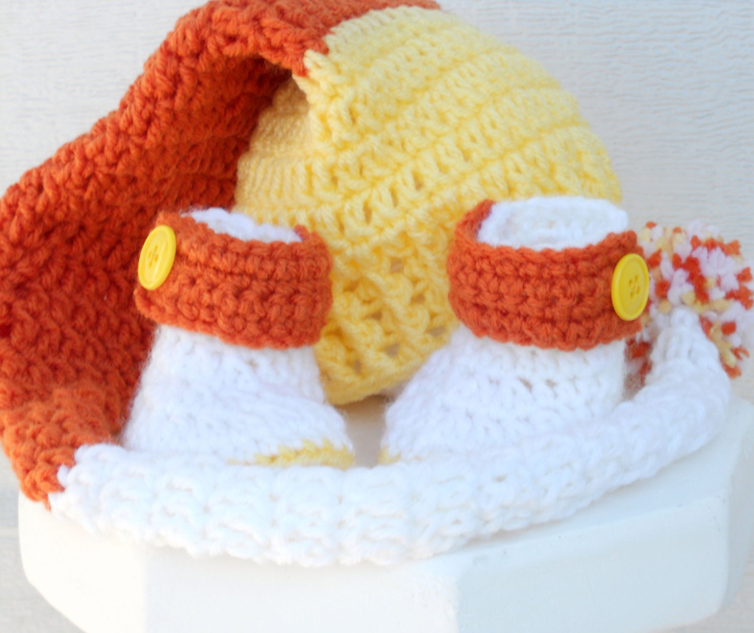 Crocheted baby pixie hat and booties candy corn Halloween set.