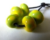 handmade lampwork glass beads, green and yellow spots